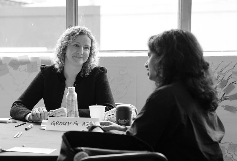 Young woman at a conference listening empathetically to her peer