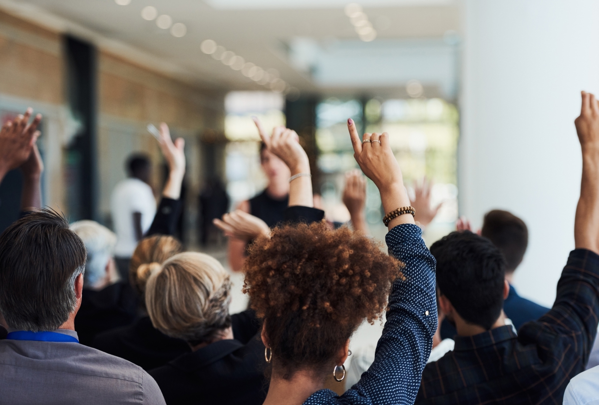 Group with arms raised in participation