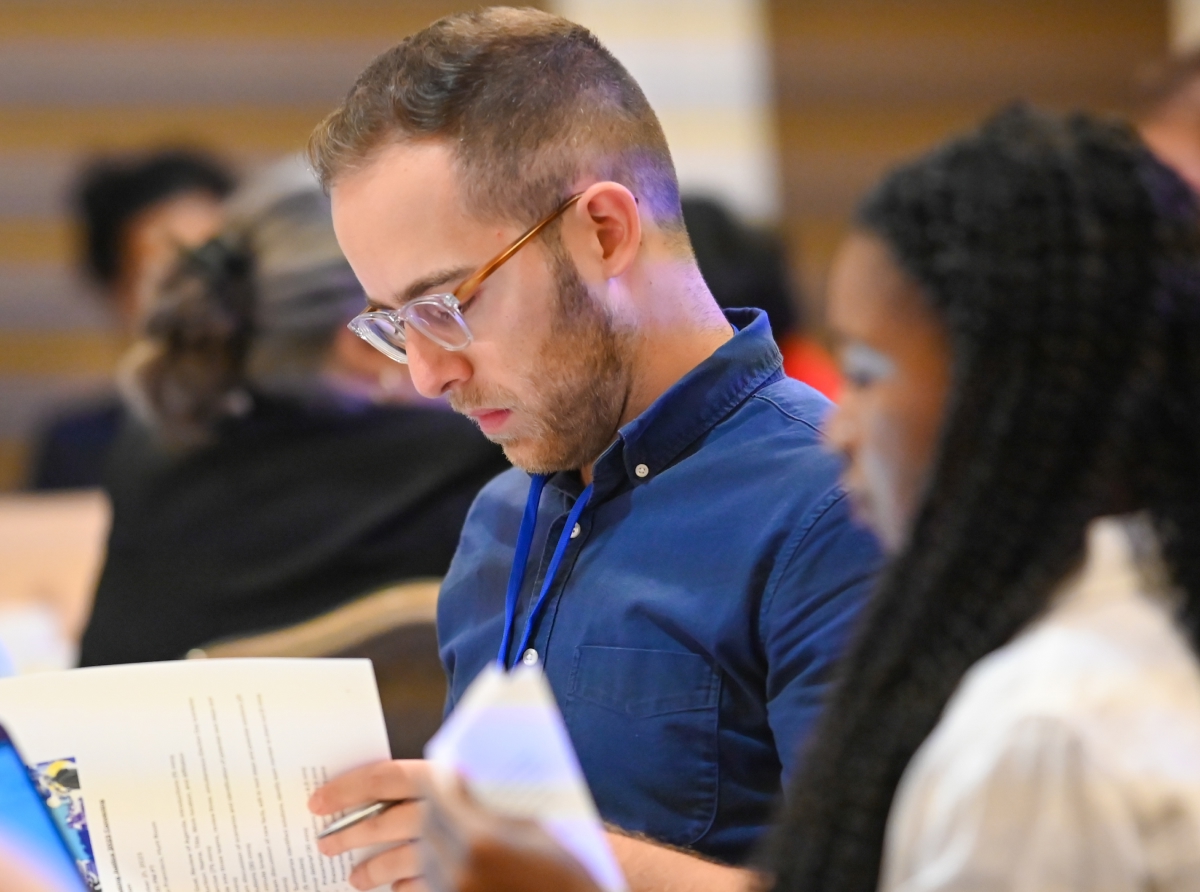 Young professionals reading meterials at a conference table