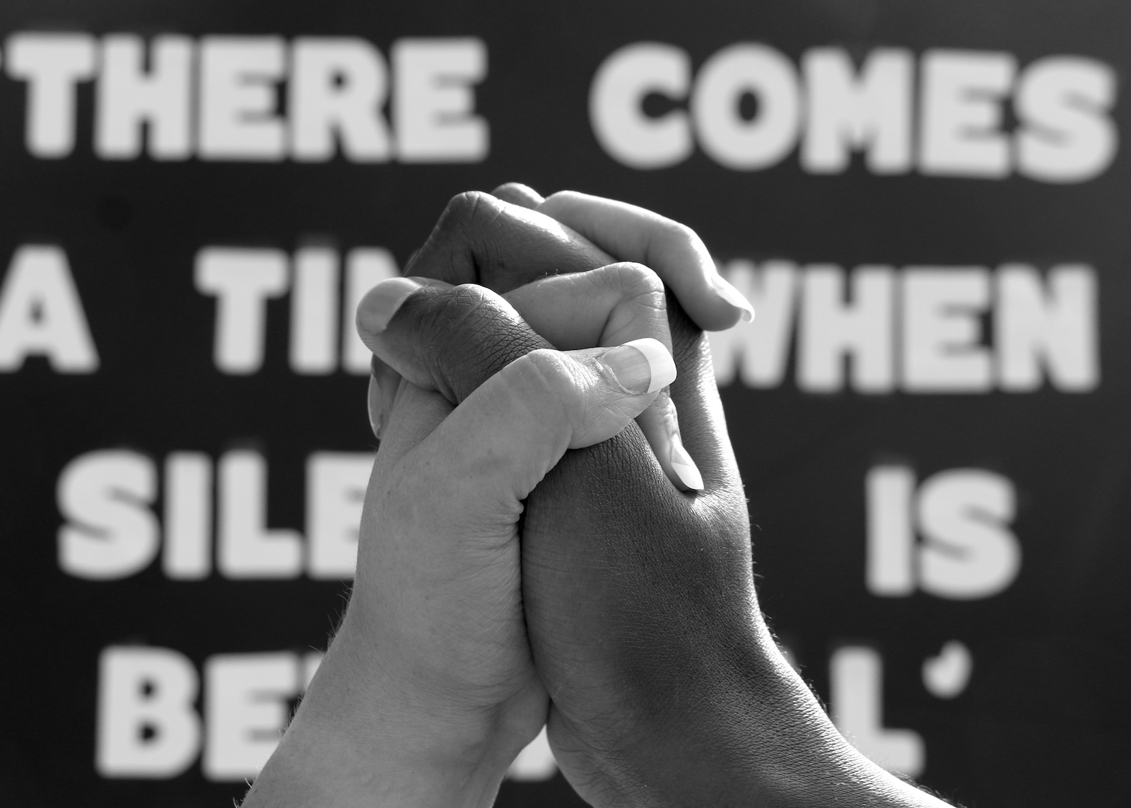 two hands gripped in solidarity
