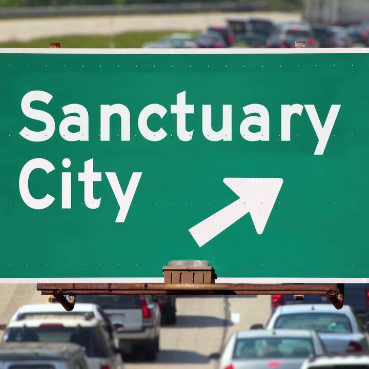 Road sign reading 'sanctuary city'